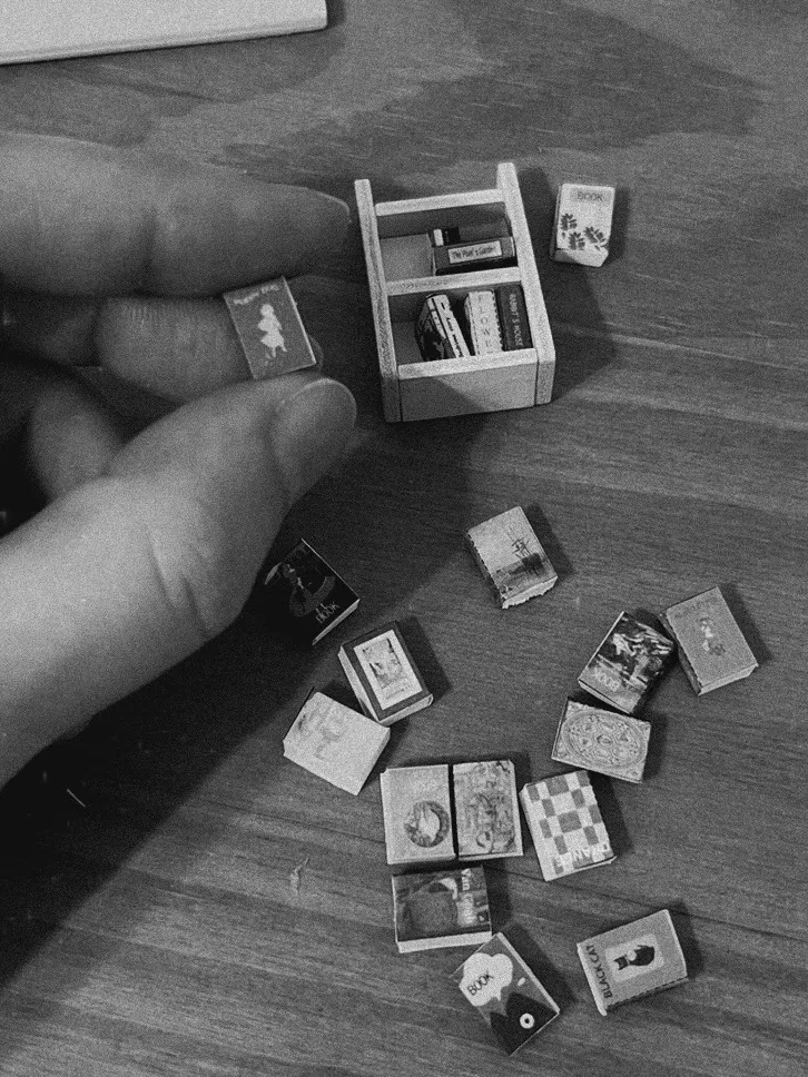 Hands building a tiny model out of small pieces